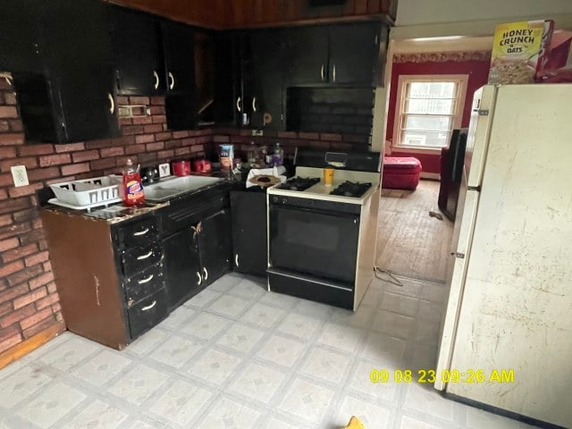 kitchen featuring backsplash and white appliances