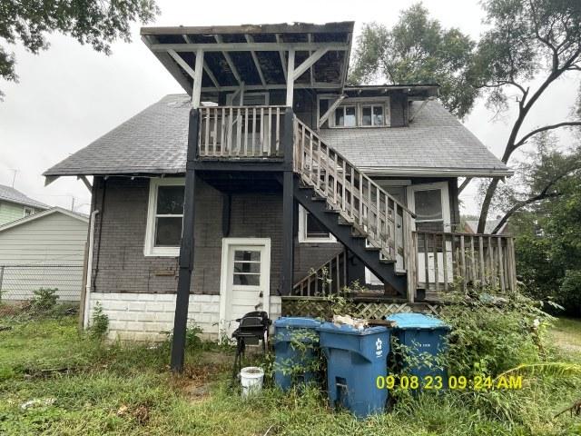 305 River Oaks Dr, Calumet City, IL 60409 - back of property featuring brick siding, stairs, and roof with shingles
