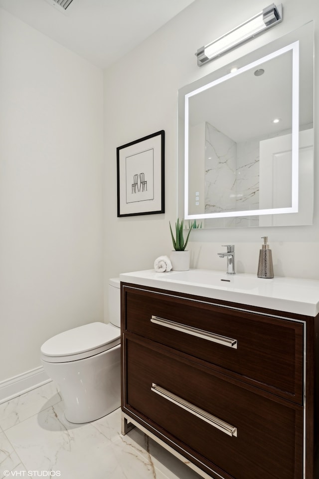 bathroom featuring vanity and toilet