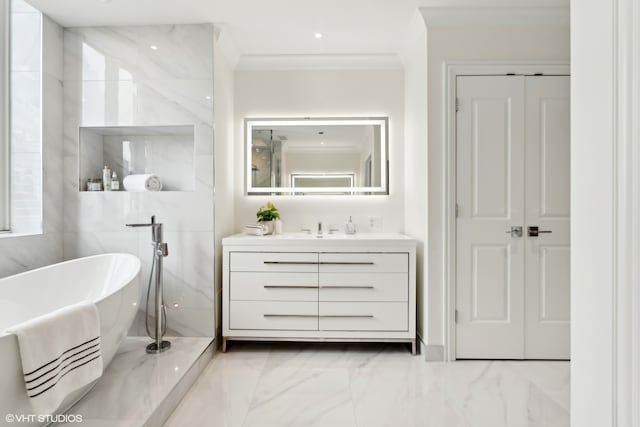 bathroom with vanity, crown molding, and a bath