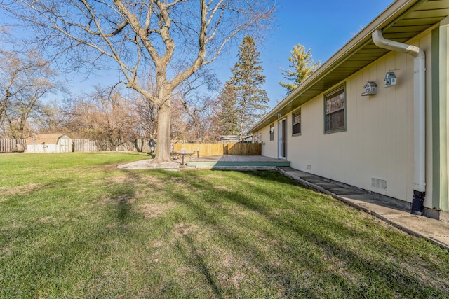 view of yard with a storage unit and a deck