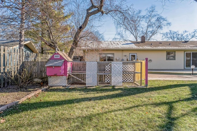 view of yard with a storage shed and a patio area