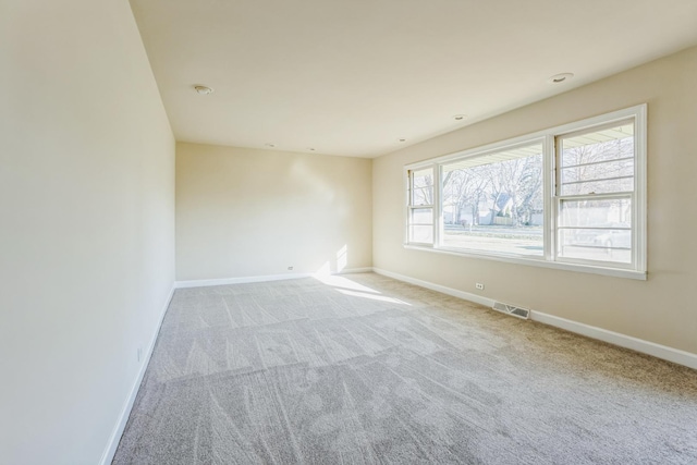 unfurnished room with light colored carpet