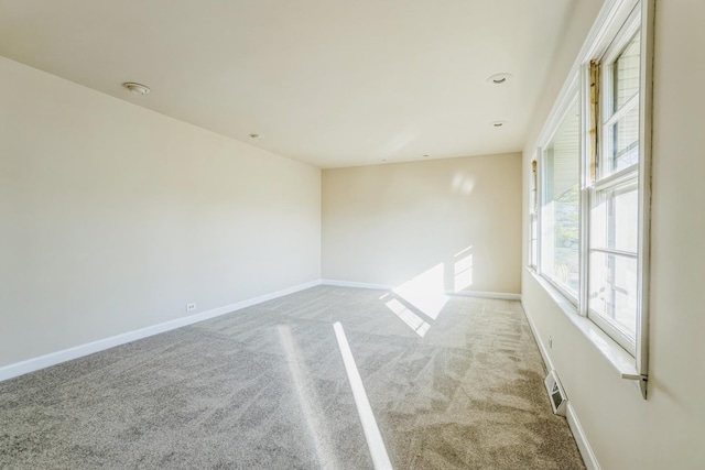 unfurnished room with light carpet