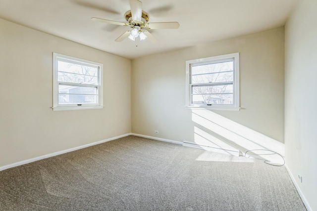 spare room with carpet flooring, a wealth of natural light, and ceiling fan