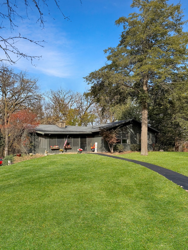 exterior space featuring an outdoor structure and a front yard