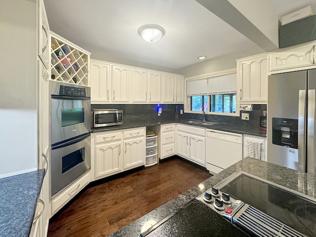 kitchen featuring appliances with stainless steel finishes, dark hardwood / wood-style floors, and white cabinetry