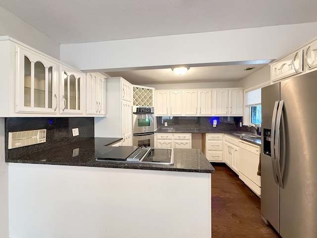 kitchen featuring decorative backsplash, sink, dark wood-type flooring, and appliances with stainless steel finishes