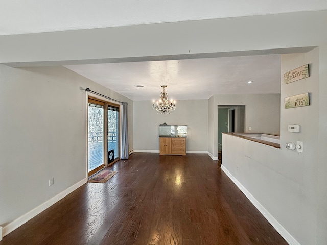 interior space with dark hardwood / wood-style flooring and a chandelier