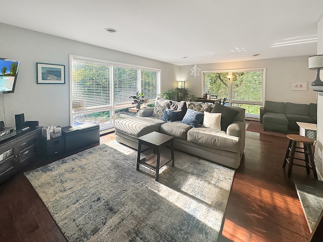 living room featuring a chandelier and dark hardwood / wood-style floors