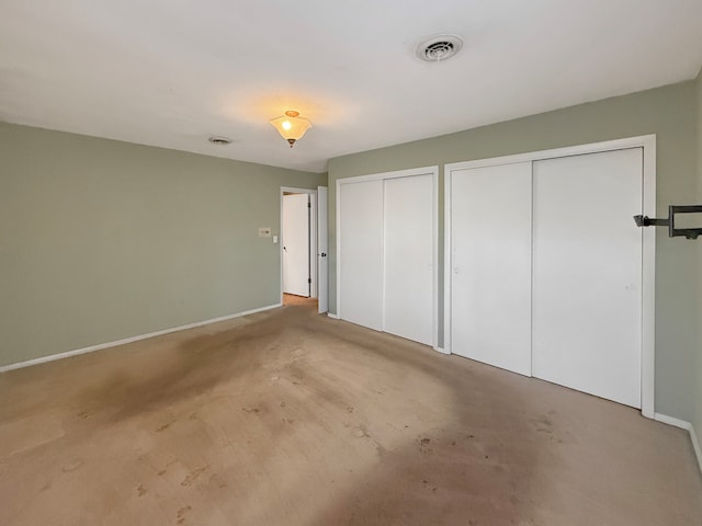 unfurnished bedroom featuring two closets