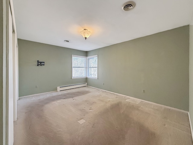 empty room with light carpet and a baseboard heating unit