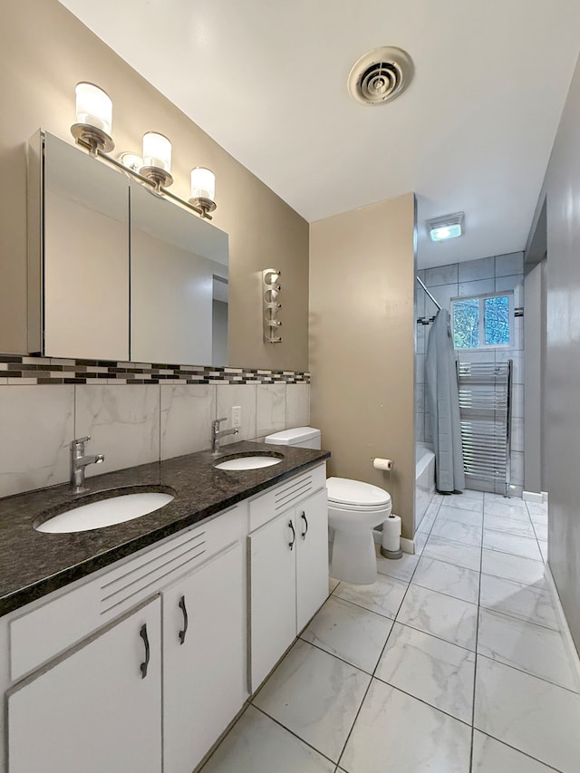 full bathroom featuring vanity, toilet, and shower / bath combo with shower curtain