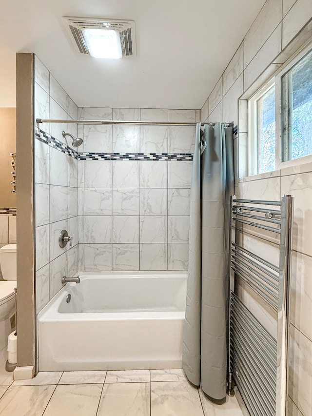 bathroom featuring toilet, radiator, and shower / bath combo with shower curtain