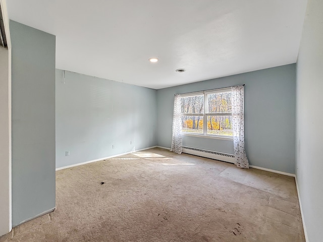 unfurnished room featuring light colored carpet and a baseboard heating unit