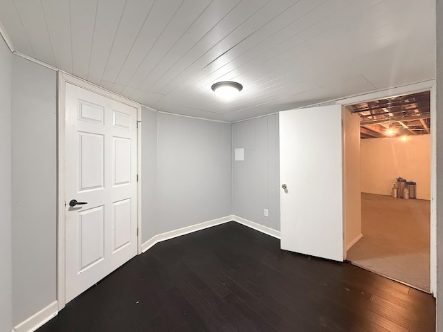 basement featuring dark hardwood / wood-style flooring