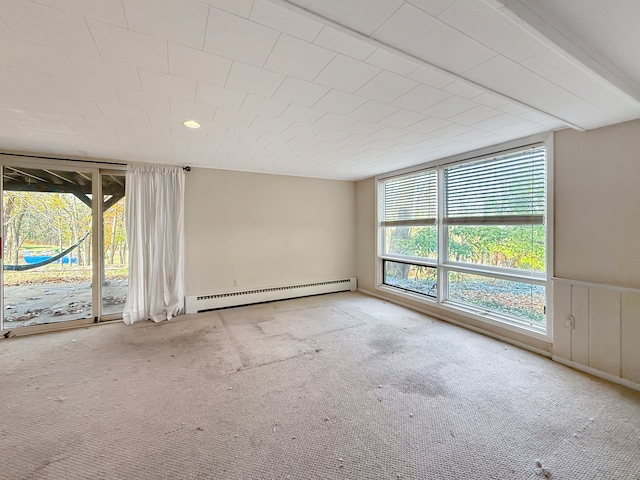 carpeted empty room featuring baseboard heating