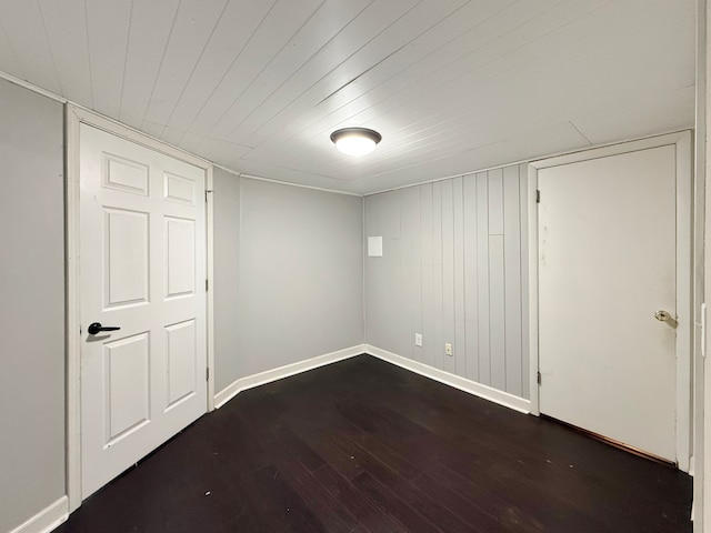 basement with dark hardwood / wood-style floors