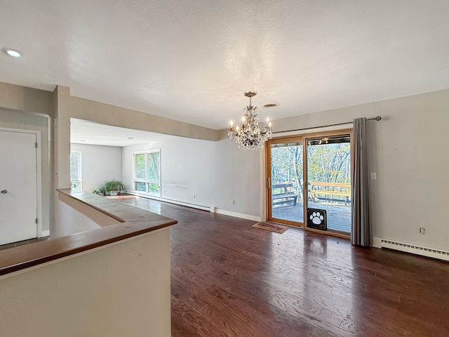 interior space with dark hardwood / wood-style floors, baseboard heating, and a notable chandelier