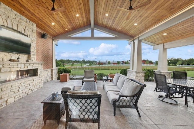 view of patio / terrace featuring an outdoor living space with a fireplace and ceiling fan