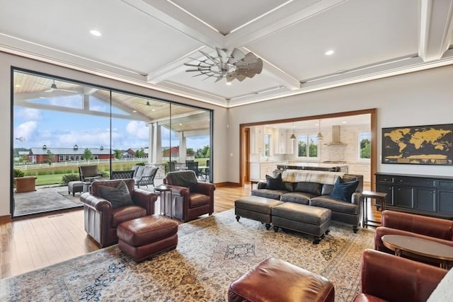 living room with beam ceiling, crown molding, ceiling fan, and wood-type flooring