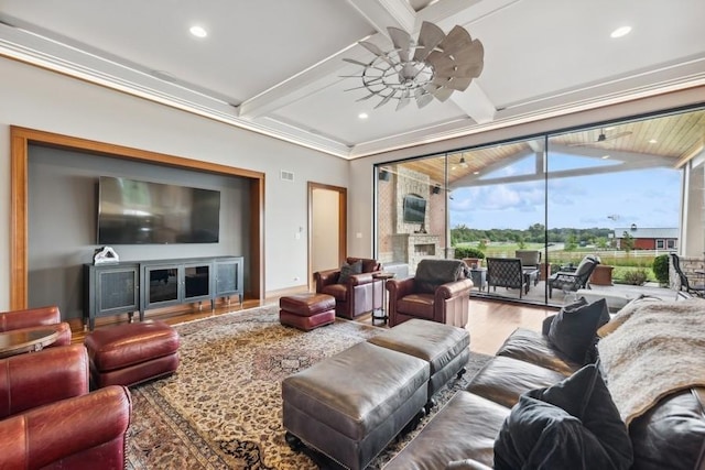 living room featuring ceiling fan, crown molding, beamed ceiling, and wood-type flooring