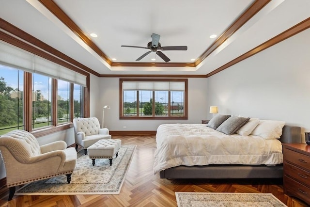 bedroom with ceiling fan, crown molding, a tray ceiling, and light parquet flooring