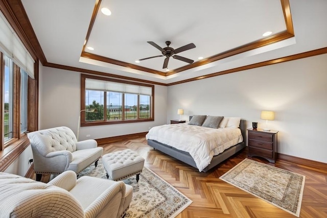 bedroom with a raised ceiling, ceiling fan, light parquet floors, and ornamental molding