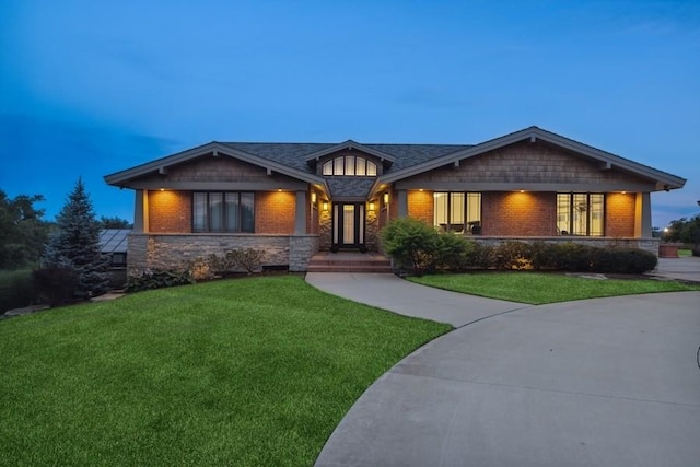 craftsman-style home with a lawn