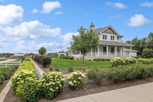 view of front of home featuring covered porch and a front lawn