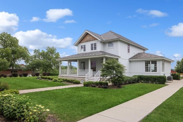 view of front of house with covered porch, cooling unit, and a front yard