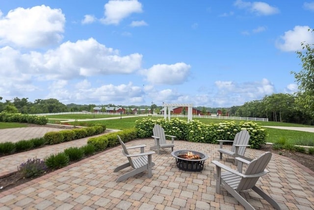 view of patio / terrace with a fire pit and a pergola