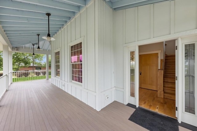 wooden deck featuring ceiling fan and a porch