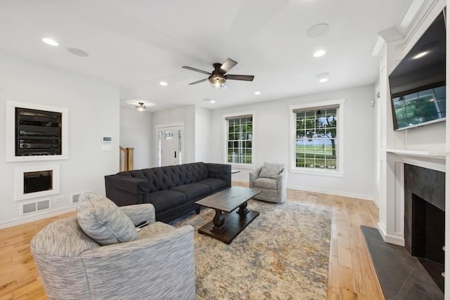 living room featuring ceiling fan and hardwood / wood-style floors