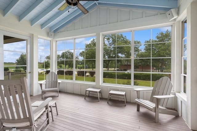 sunroom with a wealth of natural light, lofted ceiling with beams, and ceiling fan