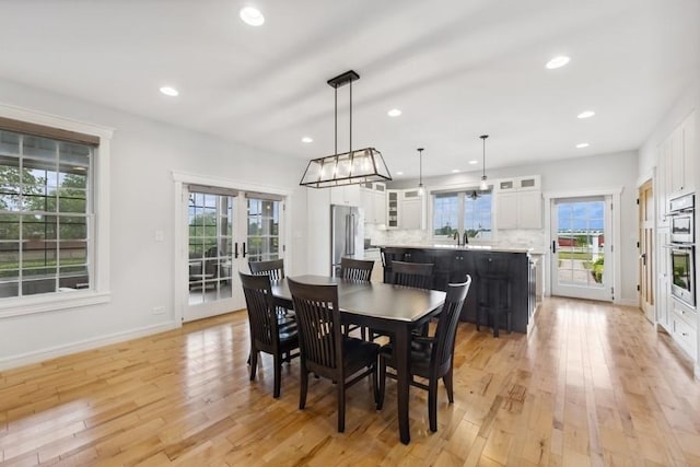 dining space featuring light wood-type flooring