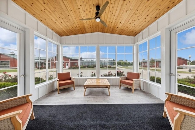 sunroom / solarium with ceiling fan, wooden ceiling, and lofted ceiling