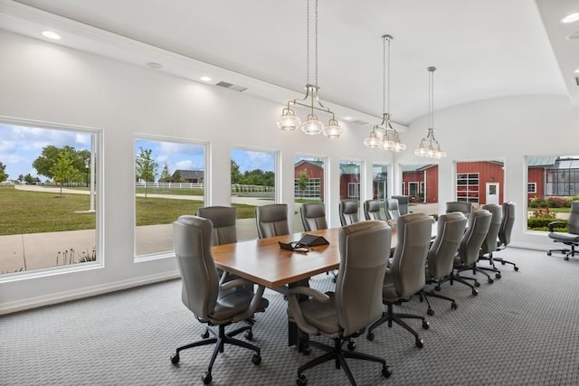 carpeted dining space with brick ceiling and vaulted ceiling