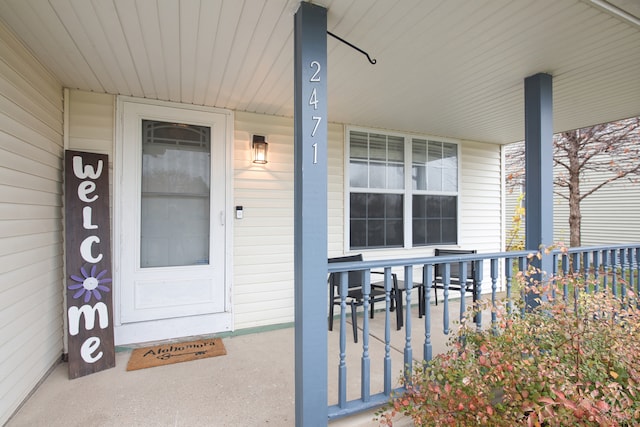 view of exterior entry with covered porch