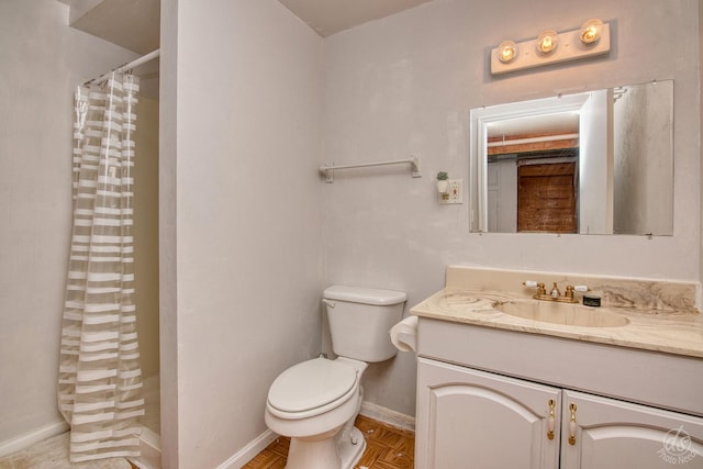 bathroom featuring curtained shower, vanity, and toilet