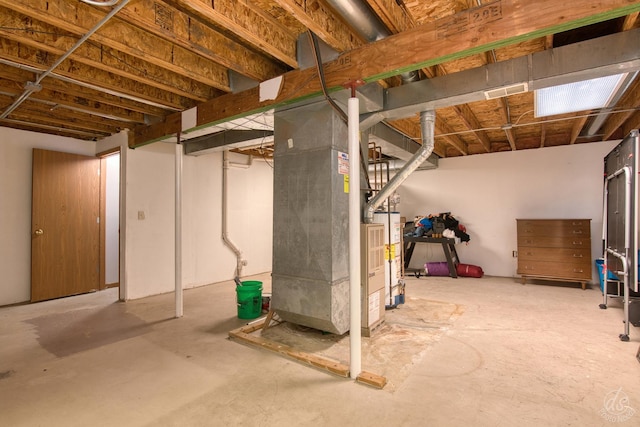 basement featuring heating unit and gas water heater