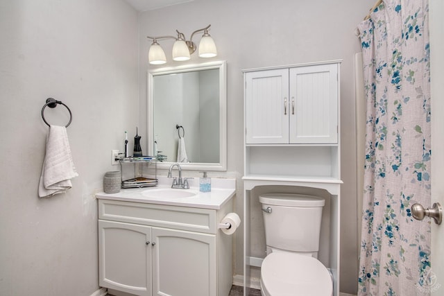 bathroom featuring vanity, a shower with shower curtain, and toilet