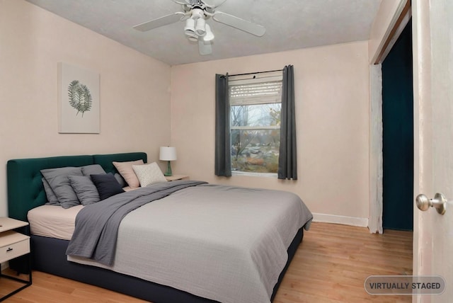 bedroom with ceiling fan and light wood-type flooring