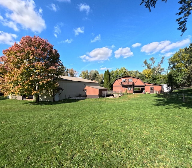 view of yard featuring an outbuilding and fence