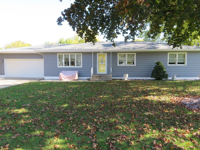 single story home featuring a garage and a front lawn