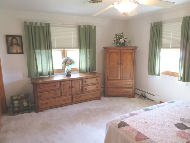 carpeted bedroom with a baseboard radiator and ceiling fan