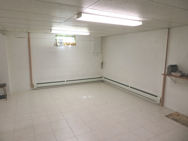 basement with baseboard heating and a drop ceiling