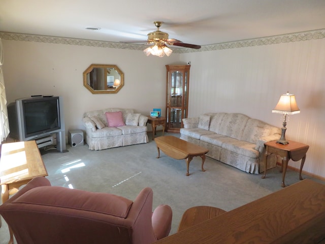 carpeted living room with ceiling fan