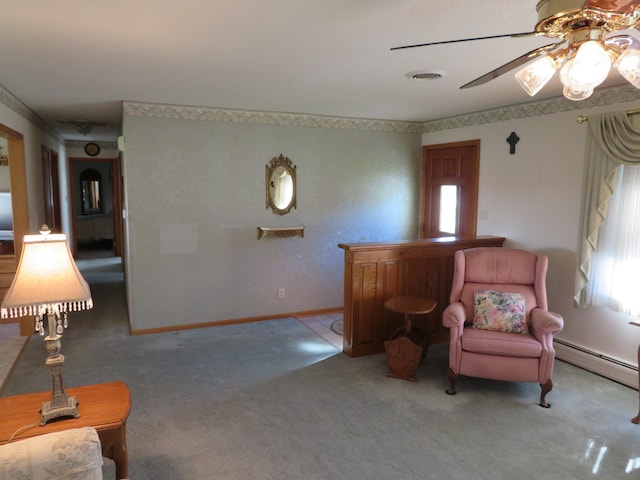 sitting room with ceiling fan, a healthy amount of sunlight, light carpet, and a baseboard radiator