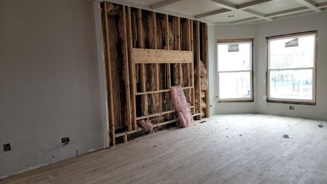 misc room featuring beamed ceiling, light hardwood / wood-style floors, and coffered ceiling